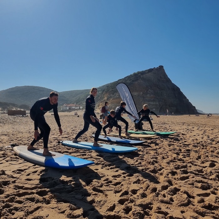 Practising on the beach with the first surf lesson