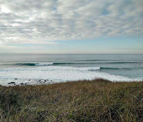 Wave breaking at the surf spot Crazy Left