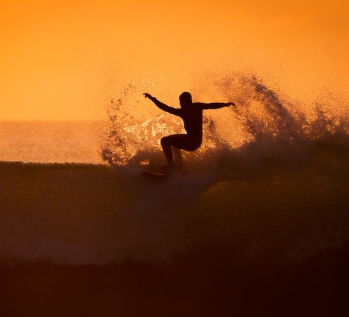 Surfer in action during sunset
