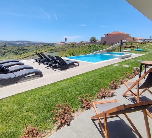 Garden with sun loungers, pool and bean bags